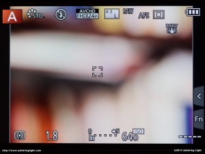 The Panasonic GX7's rear LCD, showing the main shooting information and the current focus point, positioned in the center and set to the smallest setting.