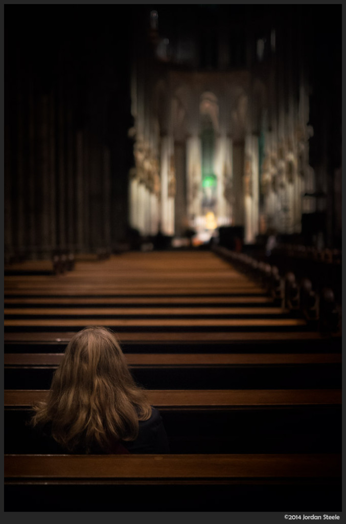 Praying in the Cathedral, Cologne, Germany - Fujifilm X-T1 with Fujinon XF 35mm f/1.4 @ f/1.4